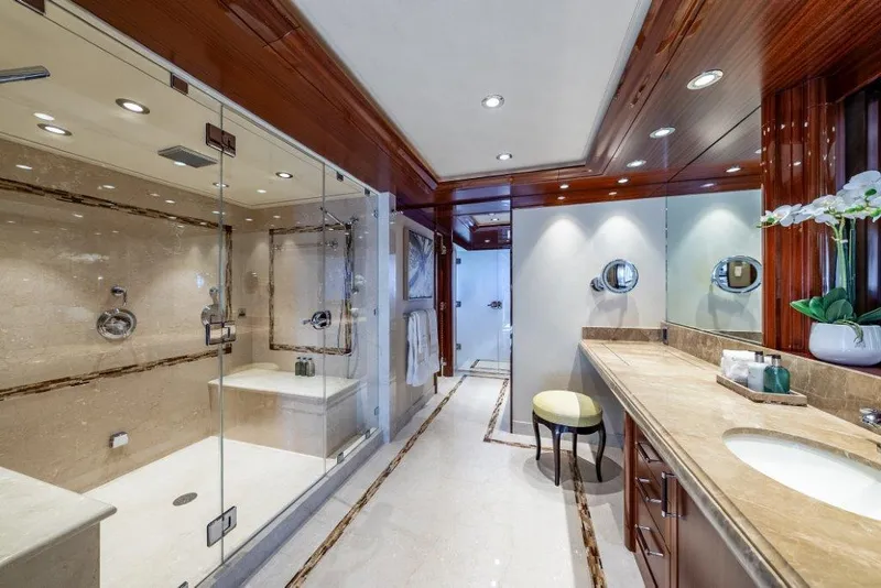Slide: The Image of Luxurious yacht bathroom with glass shower, marble countertops, and elegant wood accents, Westport W164 2013. - 17