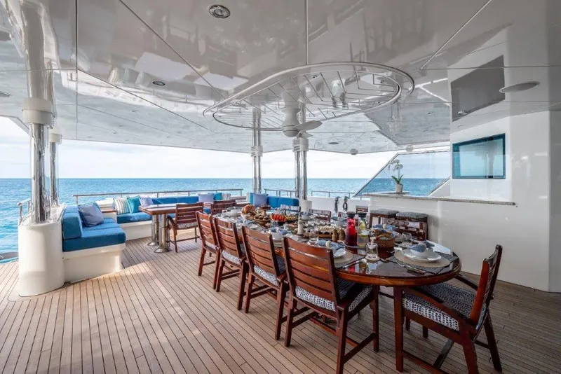 Slide: The Image of Luxurious 2013 Westport W164 yacht deck with elegant dining setup and ocean view. - 19