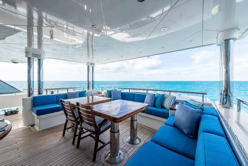 Slide: The Image of Luxurious 2013 Westport W164 yacht deck with blue seating and ocean view. - 21