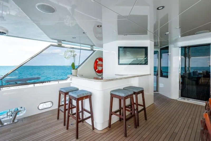 Slide: The Image of Luxurious 2013 Westport W164 yacht deck with bar stools and ocean view. - 22