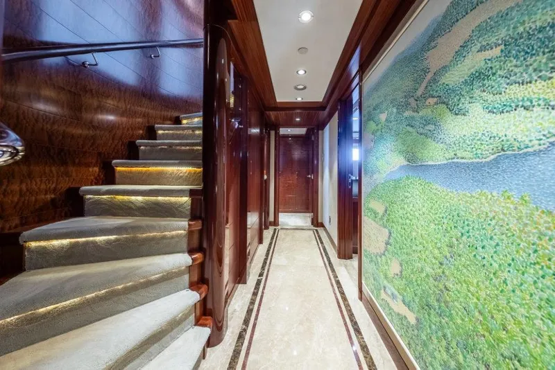 Slide: The Image of Luxurious interior of 2013 Westport W164 yacht with elegant staircase and artwork. - 33
