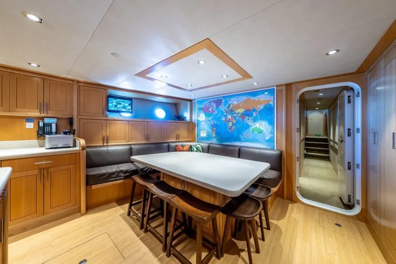 Slide: The Image of Luxurious yacht interior with dining area, world map, and modern amenities, Westport W164, 2013. - 42