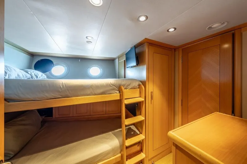 Slide: The Image of Cozy 2013 Westport W164 yacht cabin with bunk beds and wooden furnishings. - 44