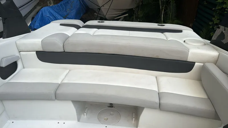 Slide: The Image of 2019 Rinker 21QX BR boat interior with white and gray seating. - 10