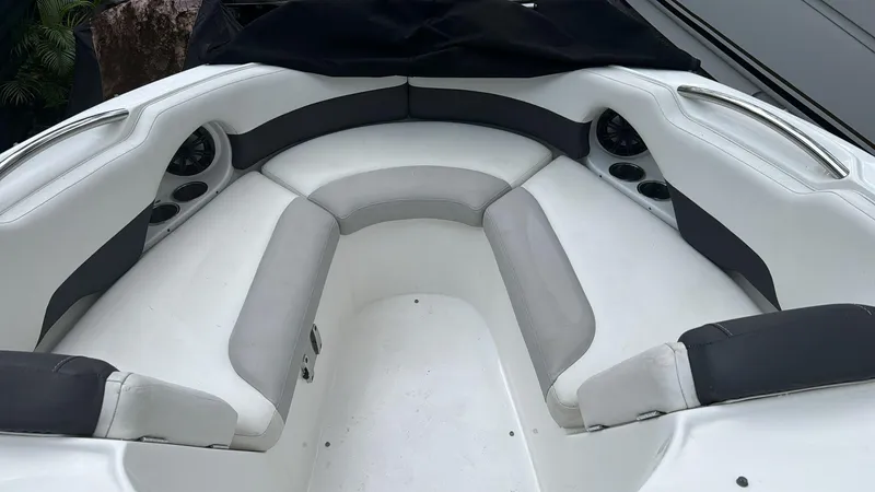 Slide: The Image of 2019 Rinker 21QX BR boat interior with white and gray seating. - 11