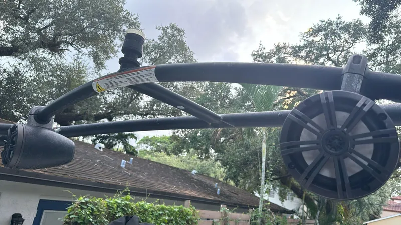 Slide: The Image of Close-up of a 2019 Rinker 21QX BR boat tower against a cloudy sky. - 2