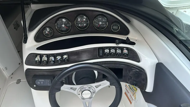 Slide: The Image of 2019 Rinker 21QX BR boat dashboard with gauges and controls. - 4