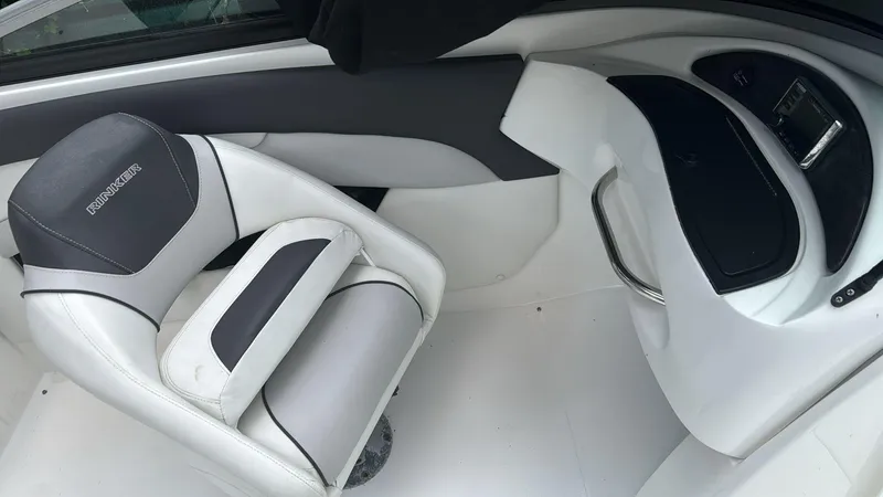 Slide: The Image of 2019 Rinker 21QX BR boat interior with white and gray seating. - 7