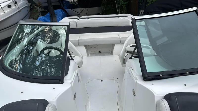 Slide: The Image of 2019 Rinker 21QX BR boat interior with dual windshields and seating. - 8