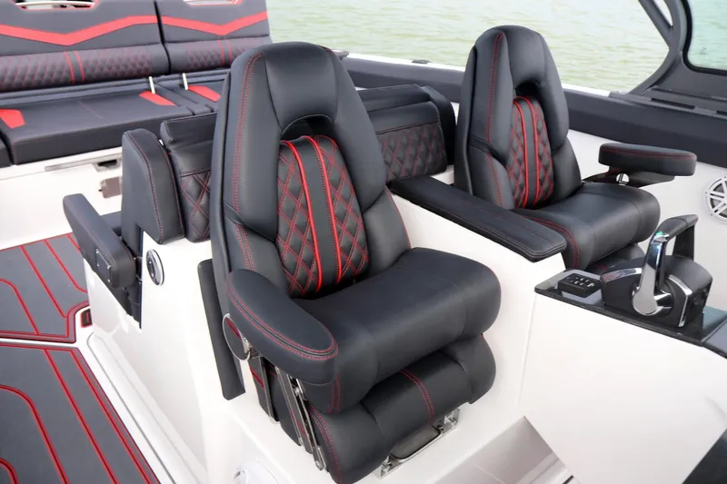 Slide: The Image of Luxury seating on 2025 Monterey Elite 30 OB boat with black and red accents. - 3