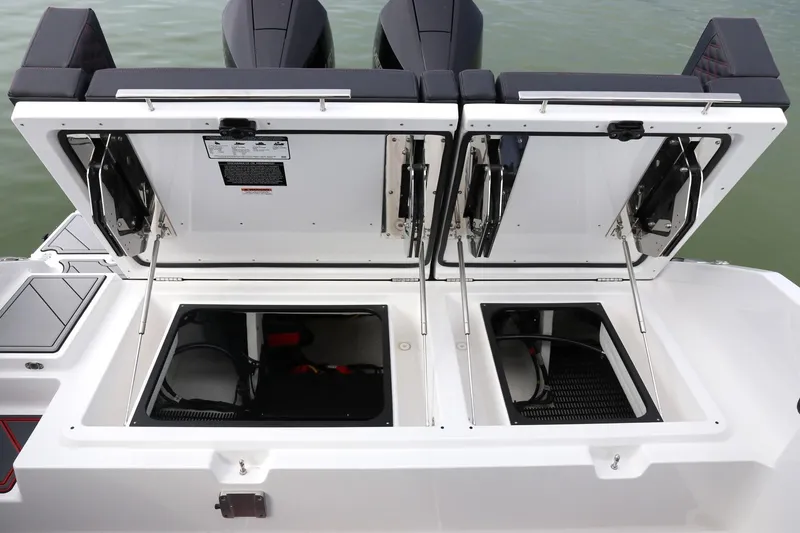 Slide: The Image of 2025 Monterey Elite 30 OB boat storage compartments open on the water. - 8