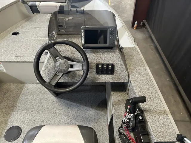 Slide: The Image of 2019 Starcraft 16 Patriot boat dashboard with steering wheel and navigation system. - 8