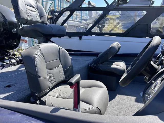 Slide: The Image of 2020 Tracker Pro Team 175 TF® boat interior with comfortable seating and steering wheel. - 4