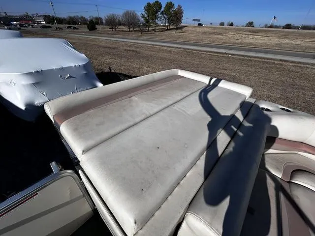 Slide: The Image of 2003 Fisher FREEDOM 240 DELUXE boat with sunbathing deck, parked outdoors. - 11