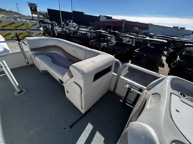 Slide: The Image of 2003 Fisher FREEDOM 240 DELUXE boat interior with seating, parked near dealership. - 14