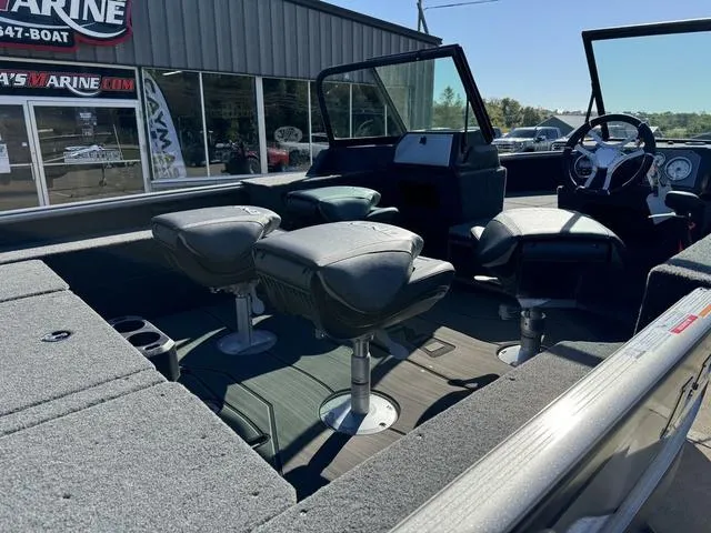 Slide: The Image of 2025 Lund 1875 Impact XS Sport boat interior with seating and steering console. - 10