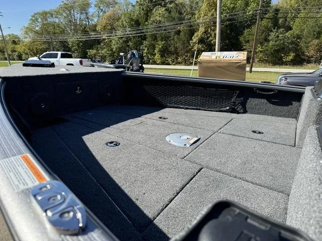 Slide: The Image of 2025 Lund 1875 Impact XS Sport boat interior with spacious deck and storage compartments. - 23