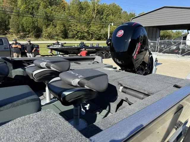 Slide: The Image of 2025 Lund 1875 Impact XS Sport boat with seating and powerful outboard motor. - 24