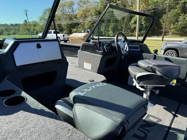 Slide: The Image of 2025 Lund 1875 Impact XS Sport boat interior with seating and steering console. - 26