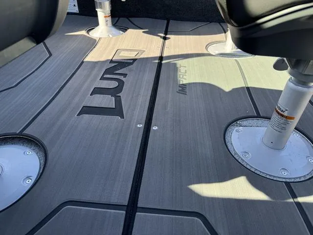 Slide: The Image of 2025 Lund 1875 Impact XS Sport boat interior flooring with logo. - 27
