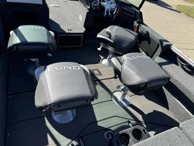 Slide: The Image of Interior of 2025 Lund 1875 Impact XS Sport boat with swivel seats and steering console. - 28