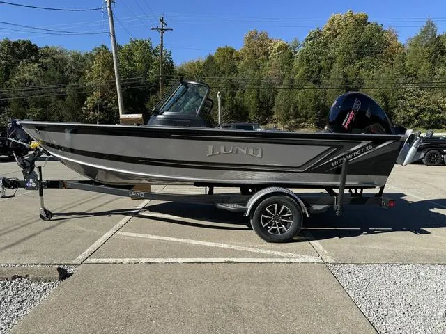 Slide: The Image of 2025 Lund 1875 Impact XS Sport boat on trailer in parking lot. - 29