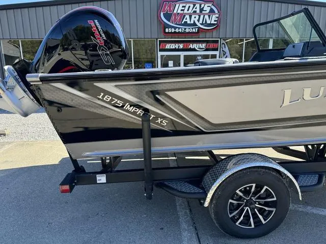 Slide: The Image of 2025 Lund 1875 Impact XS Sport boat at Weda's Marine dealership. - 6