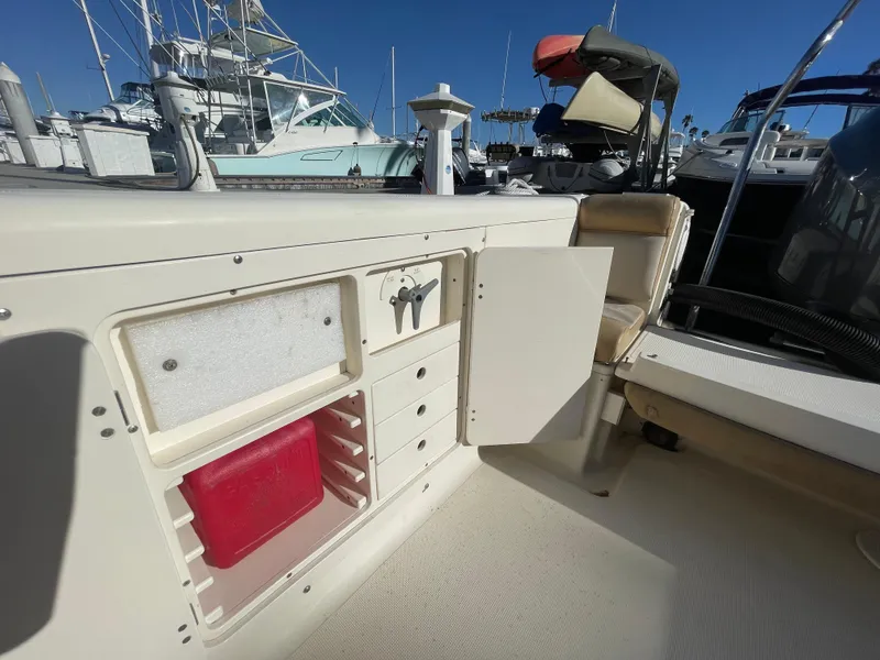 Slide: The Image of 2007 Scout 242 Sportfish boat interior with storage compartments at marina. - 10