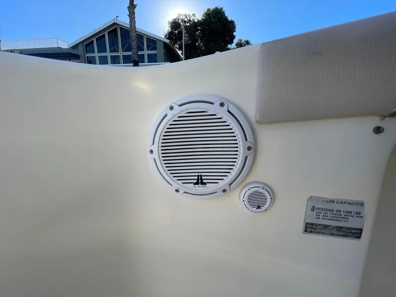 Slide: The Image of 2007 Scout 242 Sportfish boat interior with speaker and capacity label. - 15