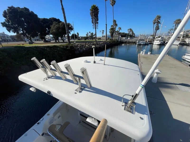 Slide: The Image of 2007 Scout 242 Sportfish boat docked in a marina, clear blue sky. - 22
