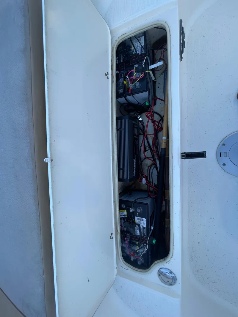 Slide: The Image of 2007 Scout 242 Sportfish battery compartment with wiring and components. - 26