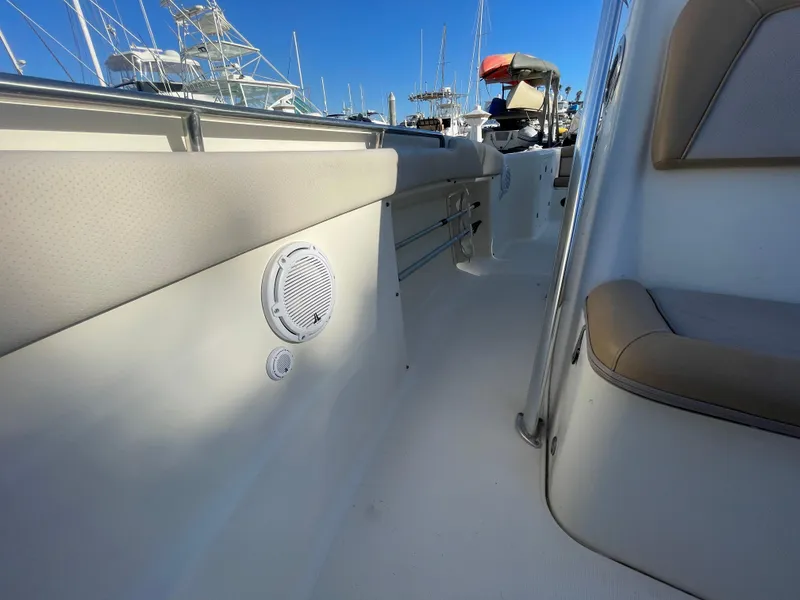 Slide: The Image of 2007 Scout 242 Sportfish boat interior with seating and speaker, docked at marina. - 30