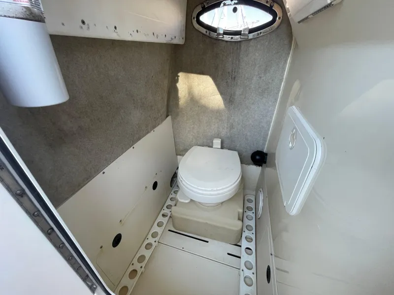 Slide: The Image of 2007 Scout 242 Sportfish boat interior with compact marine toilet. - 32
