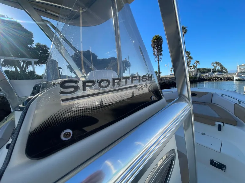 Slide: The Image of 2007 Scout 242 Sportfish boat, sleek design, docked under clear blue sky. - 34
