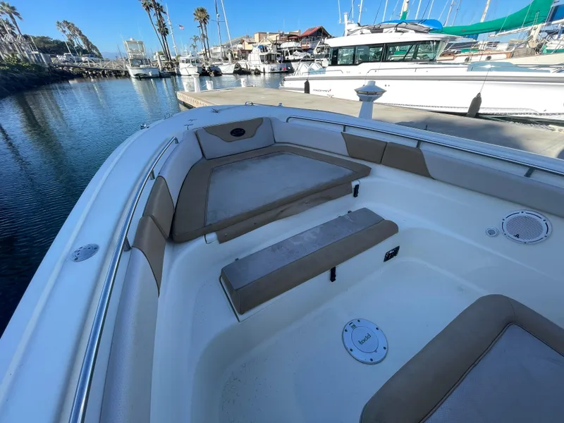 Slide: The Image of 2007 Scout 242 Sportfish boat interior with seating, docked in marina. - 36