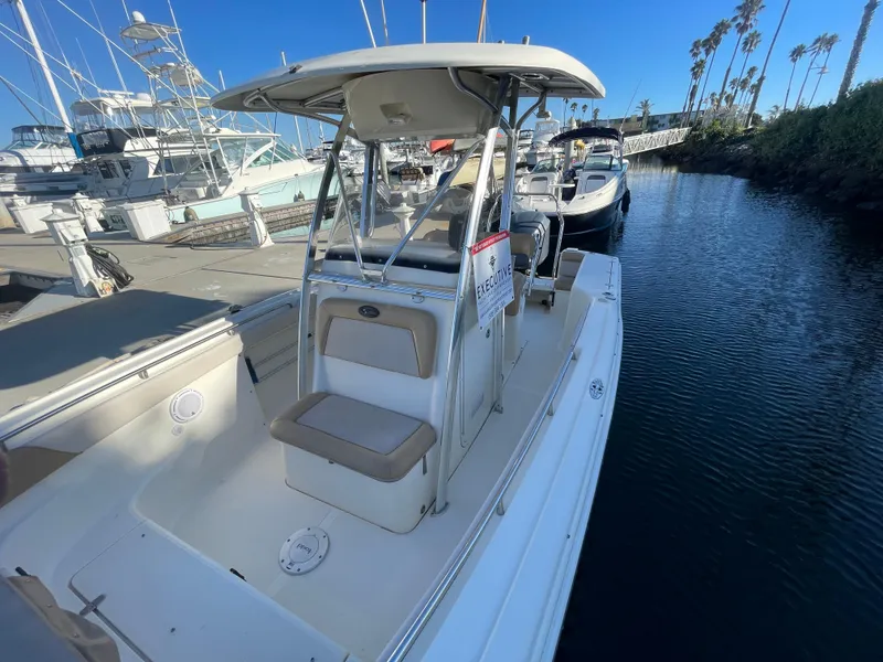 Slide: The Image of 2007 Scout 242 Sportfish boat docked at marina, clear blue sky. - 39