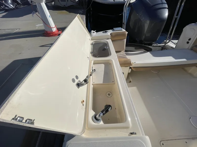 Slide: The Image of 2007 Scout 242 Sportfish boat with open storage compartments on deck. - 8