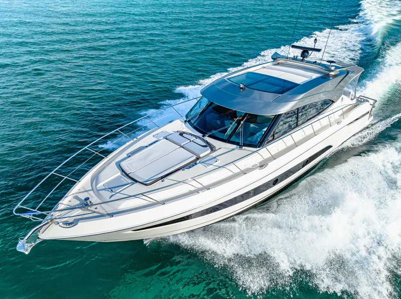 Slide: The Image of 2025 Riviera 5400 Sport Yacht cruising on open water. - 11