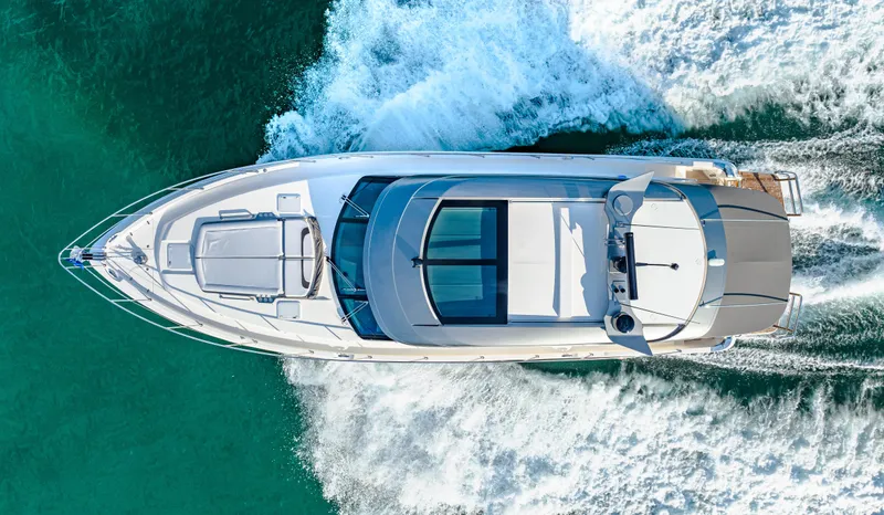 Slide: The Image of Aerial view of 2025 Riviera 5400 Sport Yacht cruising on turquoise water. - 15