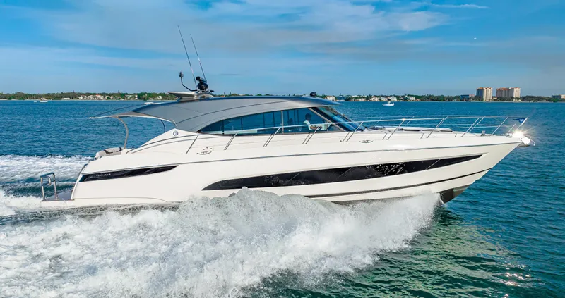 Slide: The Image of 2025 Riviera 5400 Sport Yacht cruising on open water. - 16