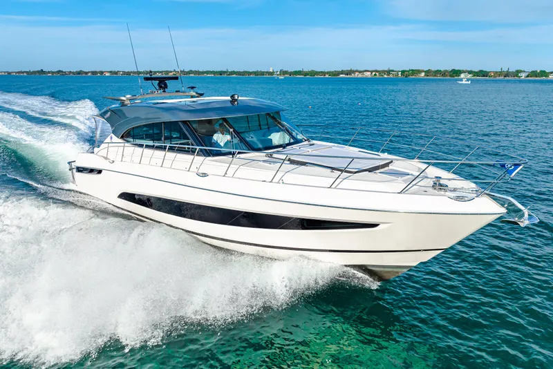 Slide: The Image of 2025 Riviera 5400 Sport Yacht cruising on open water. - 18
