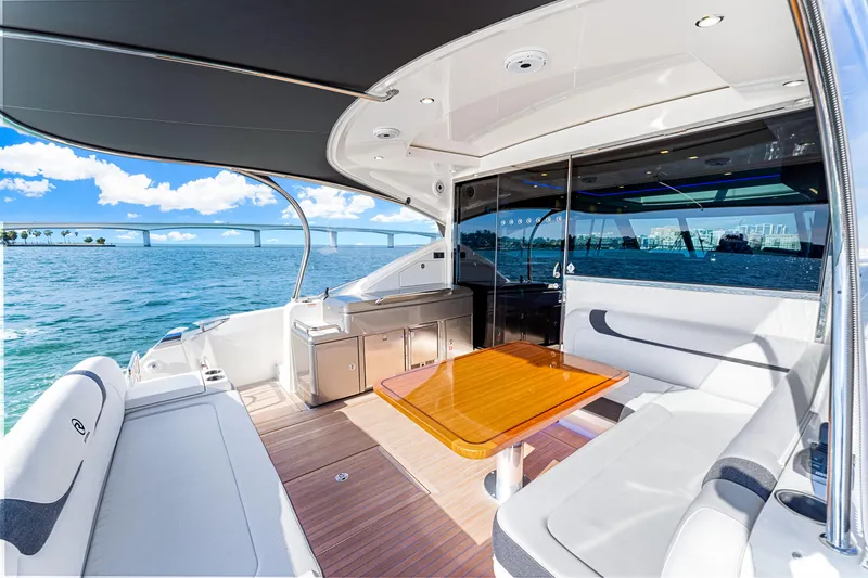 Slide: The Image of Luxurious 2025 Riviera 5400 Sport Yacht interior with ocean view and modern seating. - 28