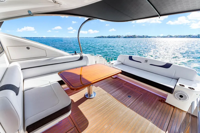 Slide: The Image of Luxurious 2025 Riviera 5400 Sport Yacht deck with ocean view and elegant seating. - 31