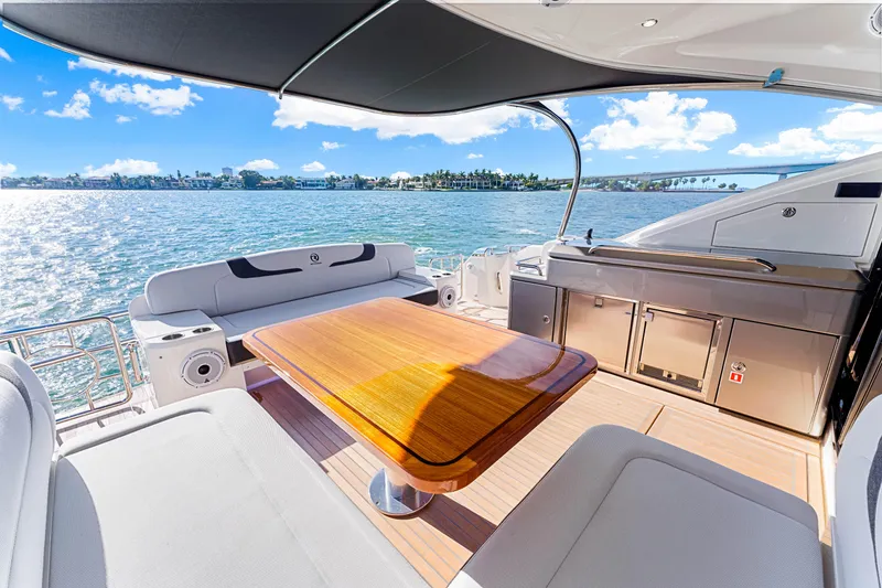 Slide: The Image of Luxurious 2025 Riviera 5400 Sport Yacht deck with ocean view and elegant seating area. - 32