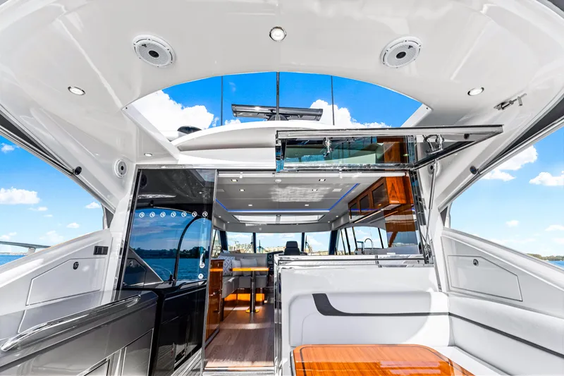 Slide: The Image of Interior of 2025 Riviera 5400 Sport Yacht with modern design and open sky view. - 37