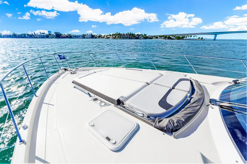 Slide: The Image of Riviera 5400 Sport Yacht 2025 cruising on sunny waters with scenic bridge view. - 40