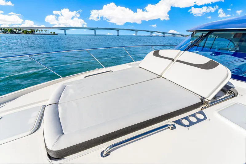Slide: The Image of 2025 Riviera 5400 Sport Yacht on water with bridge in background. - 42