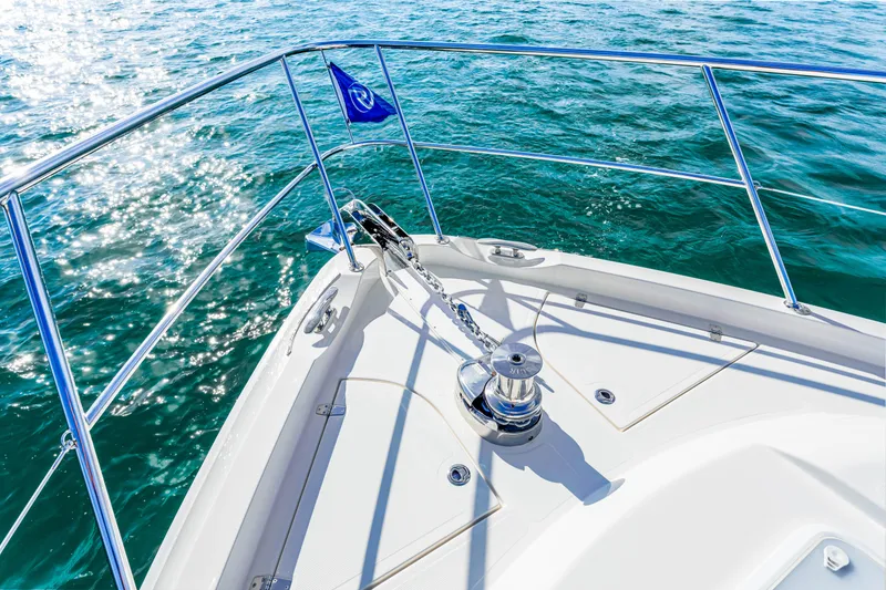 Slide: The Image of Bow of 2025 Riviera 5400 Sport Yacht on sparkling blue water. - 47