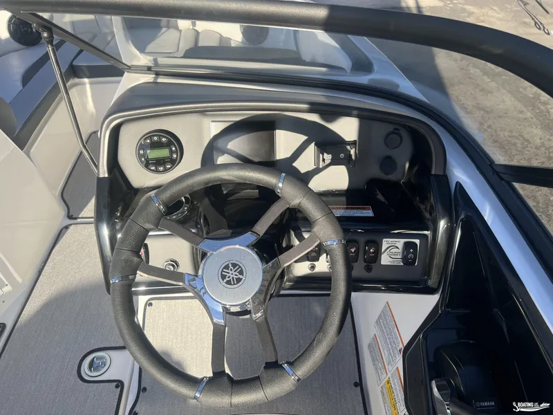Slide: The Image of 2025 Yamaha AR195 boat dashboard with steering wheel and control panel. - 4