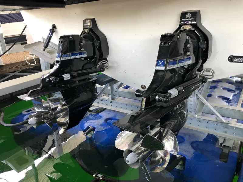 Slide: The Image of 2018 Sea Ray Sundancer 350 Coupe boat propellers and drives in a marina. - 12